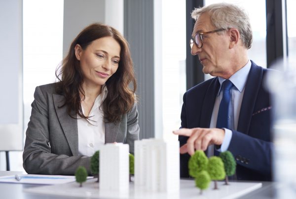 A male coworker gives advice to a female colleague about Royal Bank of Scotland debt consolidation loans